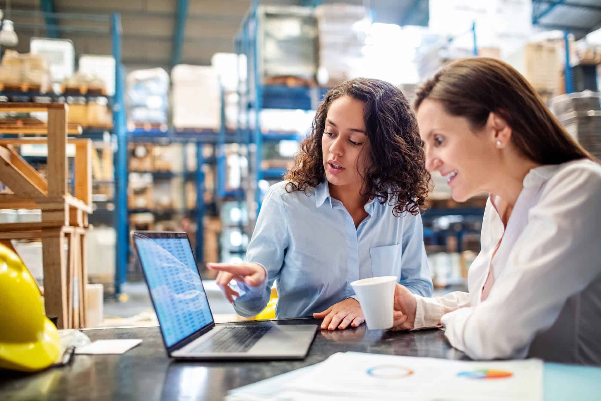team_members_working_at_desk_in_warehouse
