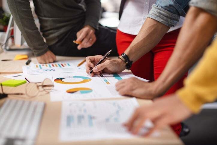 team_reviewing_charts_on_table